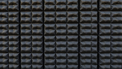 Fototapeta premium texture of the wall of black color in convex squares