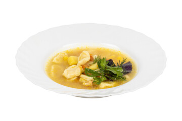 A bowl of meatball soup with vegetables on a white background