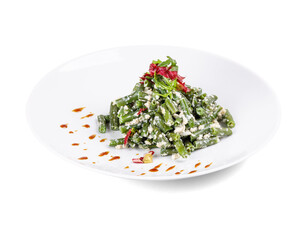 A white plate with green beans and sauce on a white background