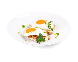 Two perfectly fried eggs served on a white plate garnished with parsley on top