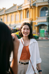 Fototapeta premium Young tourist posing for photo in front of ministry of defense in bangkok