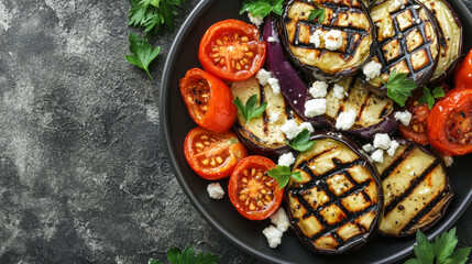A nutritious vegetarian dish consisting of grilled eggplants, tomatoes, and feta cheese, beautifully arranged on a gray stone tabletop with ample copy space