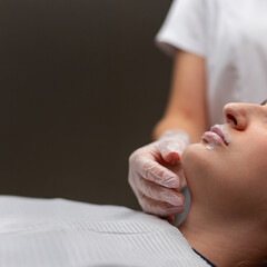 The girl is undergoing procedures at a beauty clinic. Lip augmentation and correction. The...