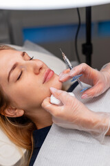 Professional female cosmetologist makes filler injection in beauty clinic. Lip augmentation and...