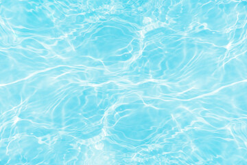 Blue water with ripples on the surface. Defocus blurred transparent blue colored clear calm water surface texture with splashes and bubbles. Water waves with shining pattern texture background.