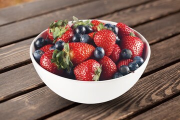Fresh ripe sweet berries in bowl