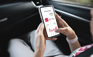 Young woman monitoring home electricity usage with mobile apps. Eco-friendly technologies and practices concept