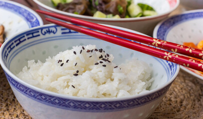 Chinese chopsticks on a bowl with white rice