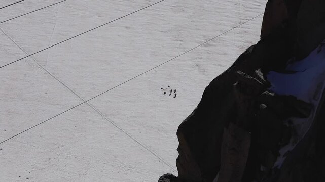 looking down on explorers on snow at the top of mount blanc