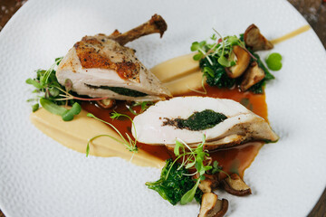 Exquisite Gourmet Chicken Dish Featuring a Savory Herb Filling and Colorful Vegetable Garnish