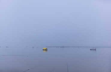 Landscape of river ganga with wooden boat in triveni sangam river during mahakumbh festival to take devotees for travel.