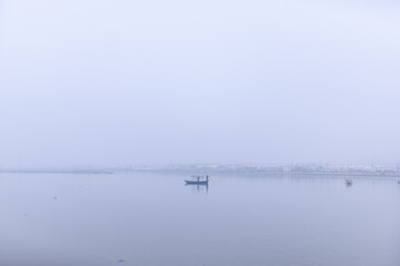 Landscape of river ganga with wooden boat in triveni sangam river during mahakumbh festival to take...