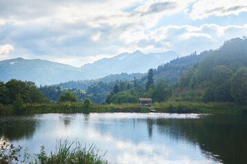 Fototapeta premium A mountain lake. Reflection of mountain peaks in the water. Natural landscape