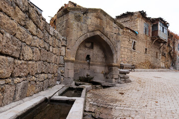 old stone house and old street fountain