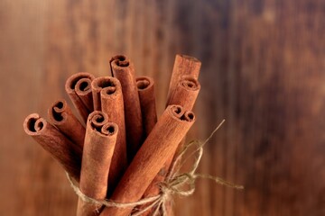 Aroma dry Cinnamon sticks on wooden background.