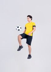 Portrait of Asian man playing soccer on white background