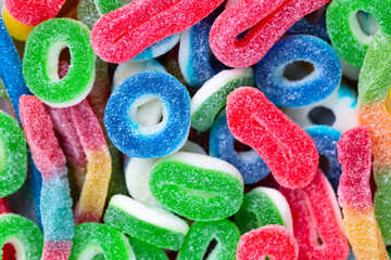 Sugar jelly sweet marmalade ring candies background. Tasty colorful chewy gummy sweets treat