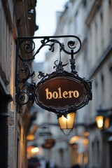 A Picturesque Street Scene Featuring an Ornate Sign with Intricate Ironwork Illuminated by Soft Glowing Lanterns, Creating a Cozy Ambiance