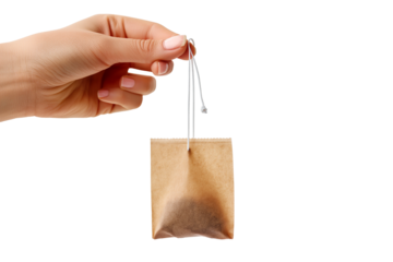Hand holding a tea bag isolated on white and transparent background, cut out png
