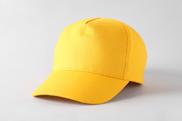 Stylish yellow baseball cap on light grey background. Mockup for design
