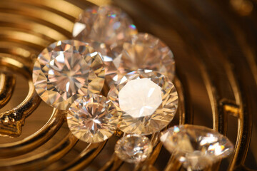 Beautiful shiny gemstones on golden tray, closeup