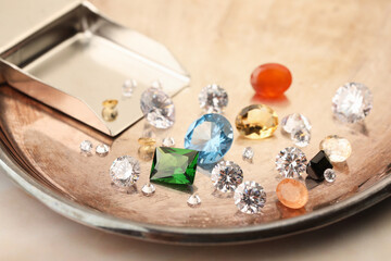 Tray with beautiful gemstones on light table, closeup