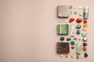 Different natural gemstones on light background, flat lay. Space for text