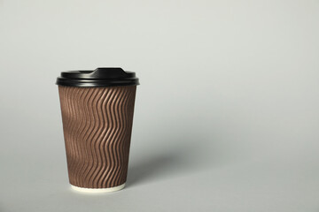 Paper cup with lid on grey background. Mockup for design