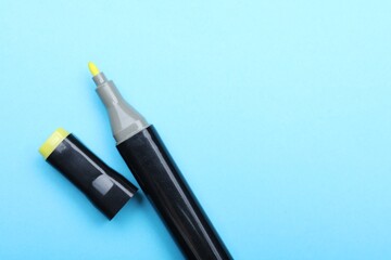 One color marker on light blue background, top view. Space for text