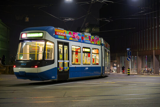 Tram arriving at tram station named ETH Universit&auml;tsspital at Swiss City of Z&uuml;rich on a dark winter night. Photo taken February 19th, 2025, Z&uuml;rich, Switzerland.