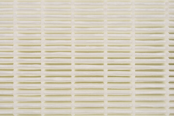 A close-up photograph of a vacuum cleaner filter, showcasing its intricate pleated design and texture