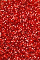 A close-up shot of pomegranate arils, showcasing their vibrant red color and juicy texture