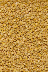 A close-up shot of dried chamomile flowers, showcasing their delicate petals and yellow centers.