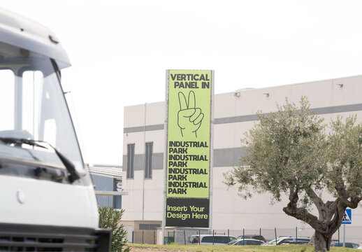 Vertical info panel stands prominently on the side of a warehouse, designed for signage in an industrial setting. Two design options