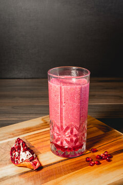 A piece of Pomegrenade with a glas of Pomegrenade juice.