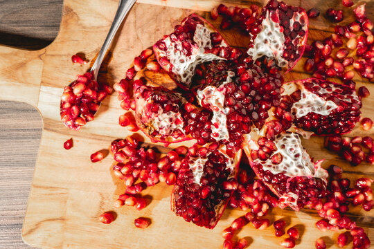 An open Pomegrenade on a wooden background.
