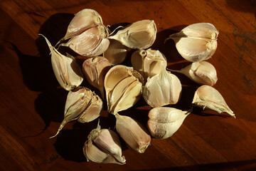 garlic clove on a wooden table background. Garlics studio shot abstract style.