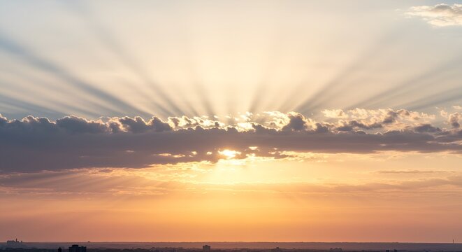 A radiant burst of sunlight with soft yellow and white rays shining through scattered clouds, creating a heavenly, uplifting mood