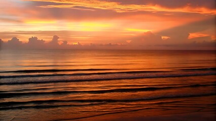 Obraz premium Breathtaking sunset over a tranquil ocean with gol