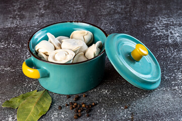 Meat dumplings - russian pelmeni in a bowl on a dark background