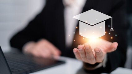 Hand holding graduation hat online learning education student university e-learning technology...