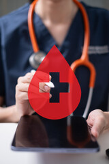 Professional health care worker doctor physician holding blood icon for blood donation concept