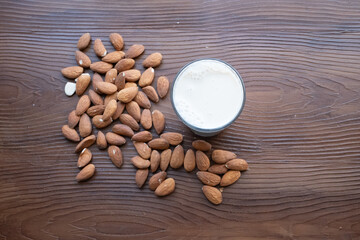 almonds milk and almonds on the wooden floor