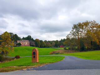 Large country house. Autumn landscape with a large trimmed lawn.