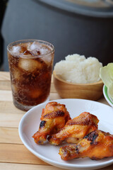 Cola soft drink with ice cubes and papaya salad spicy Thai food