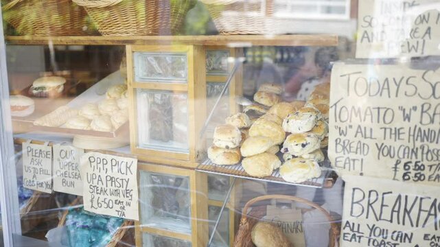 A bakery window with a sign that says "tomato w bannock" and "tomato w bannock all you can eat"