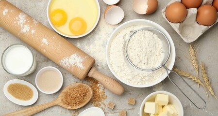 Rolling pin and different ingredients on light table, flat lay