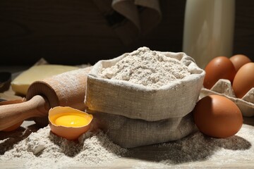 Rolling pin and different ingredients on table