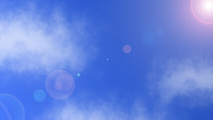 A clear blue sky with scattered clouds and a bright lens flare effect, creating a serene and radiant atmosphere
