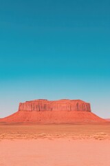 Naklejka premium Vast desert landscape showcases majestic red rock formation unde